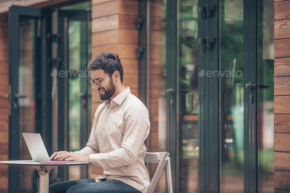 Young man with laptop outdoors Stock Photo by AboutImages | PhotoDune