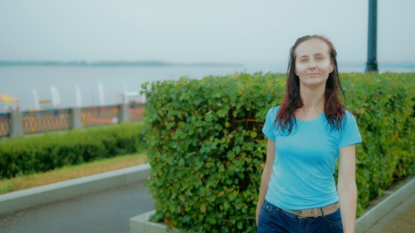 Happy Girl in the Park Walking in the Bad Weather alt