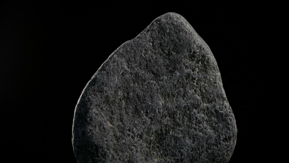 Stone Rotates On Black Background