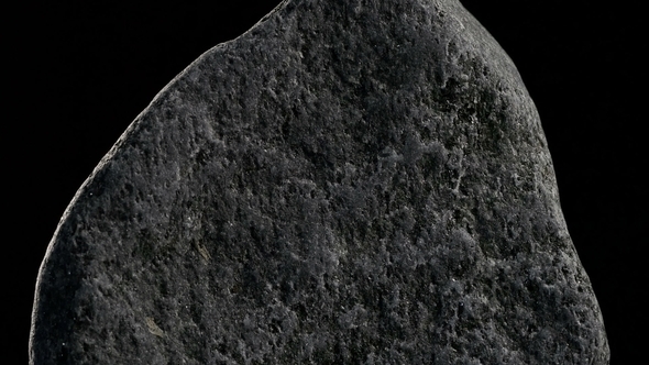 Stone Rotates On Black Background