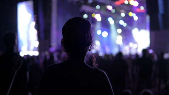 Girl Dancing at a Rock Festival