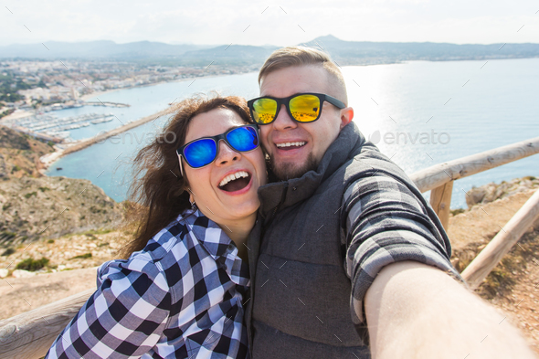 Beautiful couple having fun, taking selfie, crazy emotional faces, laughing Stock Photo by Satura_