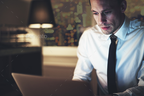 Serious businessman working on laptop - Stock Photo - Images