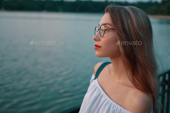 Attractive girl wearing glasses on park lake view - Stock Photo - Images