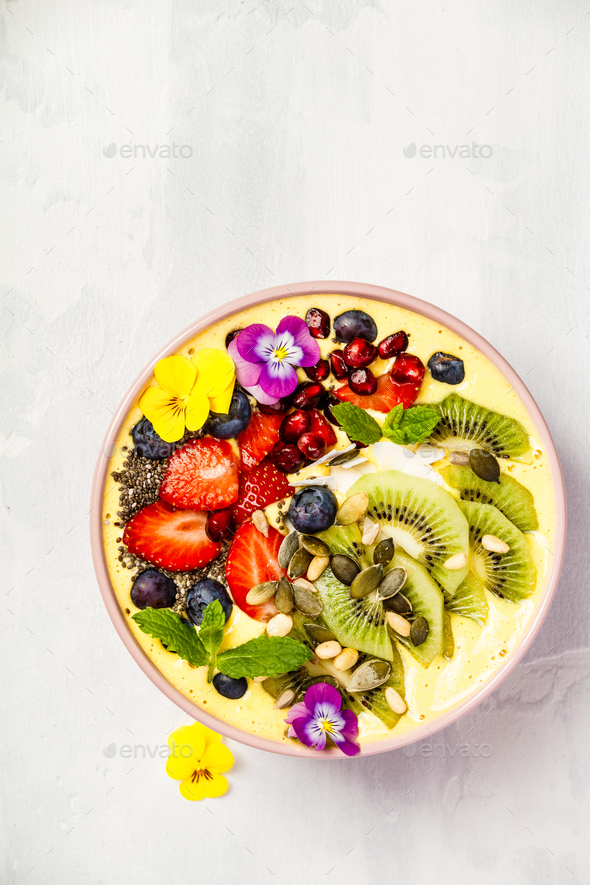 Mango banana pineapple turmeric smoothie bowl - Stock Photo - Images