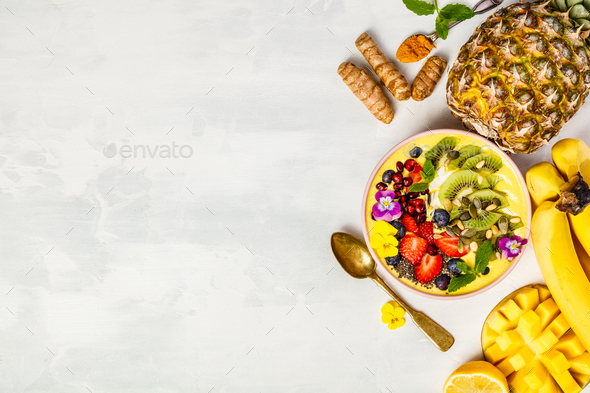 Mango banana pineapple turmeric smoothie bowl - Stock Photo - Images