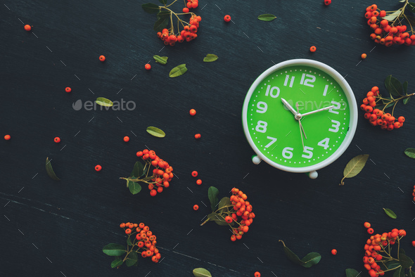 Plastic green clock on dark background, flat lay - Stock Photo - Images