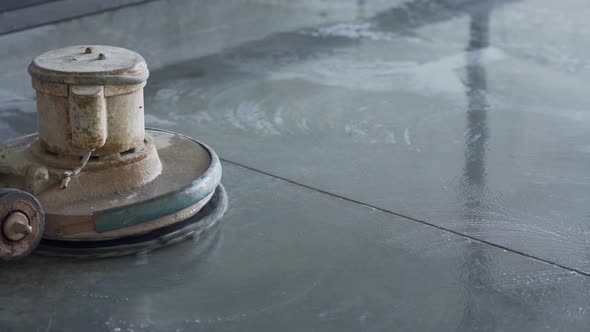 Shining concrete in factory with machine, close-up shot alt