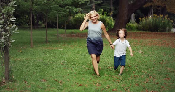 Down Syndrome Boy Running in Park