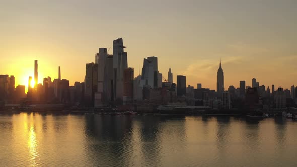An aerial view of Manhattan's westside at sunrise on a clear morning. The camera boom down with the alt