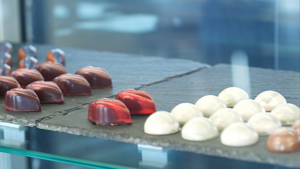 Shop Window with Stacks of Chocolate Sweets, Jellies and Candies