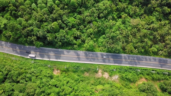 Aerial View of Transport Moving Along Road on Tropical Island in Thailand alt