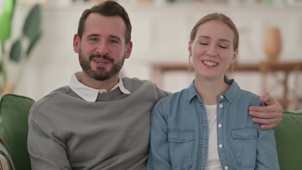 Cheerful Couple Talking on Video Call at Home alt