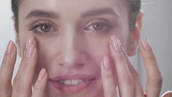 Face Care. Attractive Woman Touching Skin Under Eyes