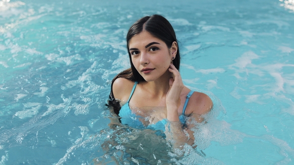 Beautiful Girl in Sexy Swimsuit Standing in the Pool, . . Portrait of Sexy Erotic Wet Girl in the