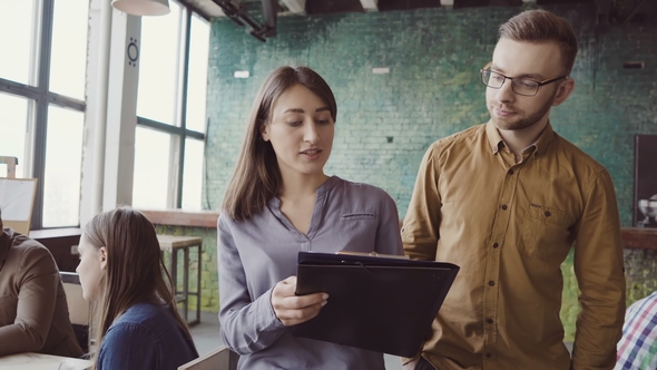 Two Colleagues Walking Through the Modern Office and Talking alt