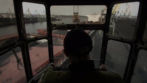 Port Crane Operator Controls Process of Moving Cargo