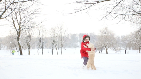 Love for Pets - a Cheerful Woman Dances and Has Fun with Her Dog in a Winter Snow-covered Park