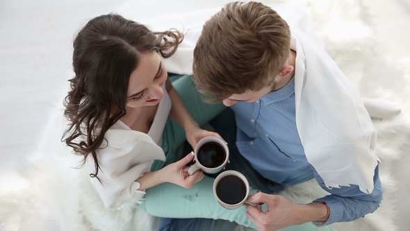 Young Couple in Love at Home Having a Cup of Coffee