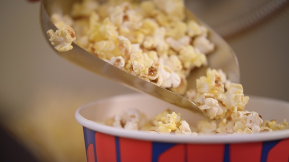 Popcorn Flakes Pouring By Ladle To Paper Container in, Stock Footage