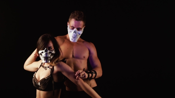 Man and Woman Dancing in Skull Masks