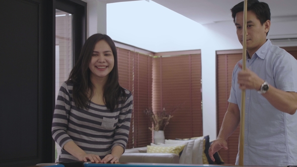 Woman Learning How To Play Billiard with Her Boyfriend