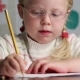 Beautiful Little Girl in Glasses with a Pencil Draws - VideoHive Item for Sale