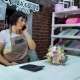 Female Florist Talking on Phone Discussing Cost of Bouquet with Customer in a Flower Shop - VideoHive Item for Sale