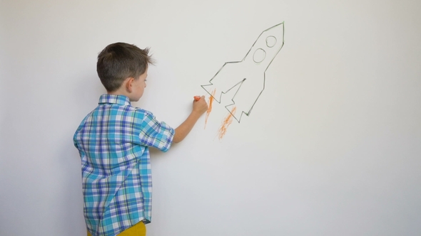 Little Child Drawing Thr Rocket on White Wall