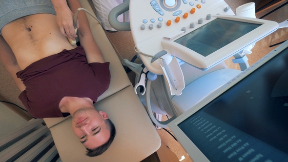 Adult Man Is Experiencing Supersonic Procedure in a Hospital Room alt