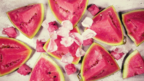 Slices of Red Watermelon on the Table with Ice Top View