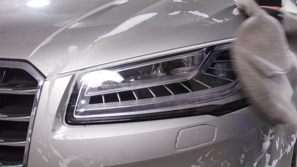 Car Detailing Concept. Man Holds the Microfiber in Hand and Polishes the Car alt