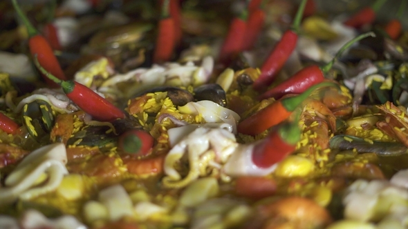 Traditional Spain Food Paella with Mussels, Shrimps, Calamari and Vegetables in Pan. . Cooking alt