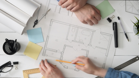 Architect Showing His House Plan To a Client