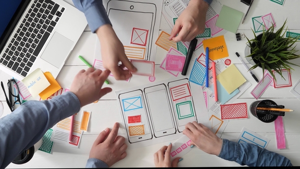 Small Team of Young UX Designers Creating Mobile App Layout alt