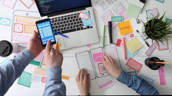 Small Team of UX Designers Discussing App Wireframe