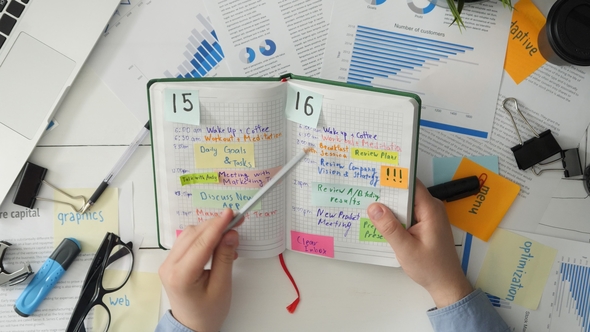 Businessman Looking at His To Do List and Checking His Work Progress