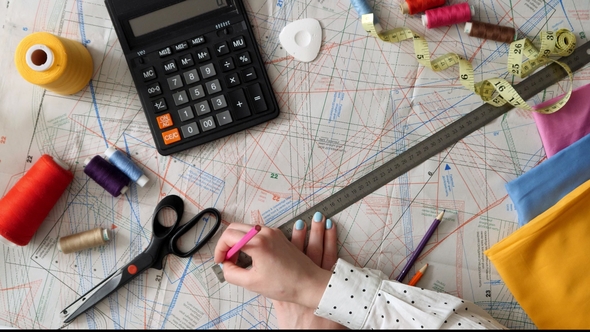 Woman Working on a Sewing Pattern alt
