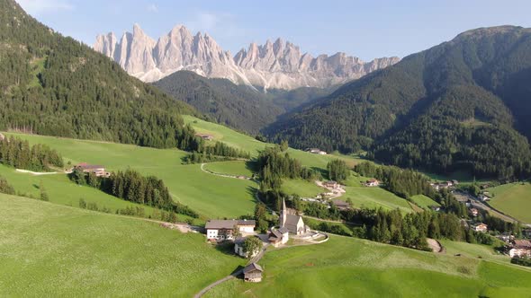 Aerial view of famous Church of Santa Maddalena in Dolomites mountains, Italy alt