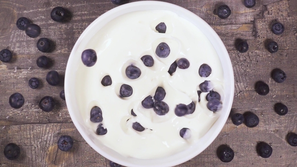 in a Bowl of Yogurt Falling Berries Top View