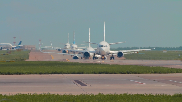 Airplanes in Queue on the Runway. Standing in Line To Take Off.