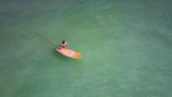 Surfers Paddle Quickly Then Fall Down Standing on Board alt