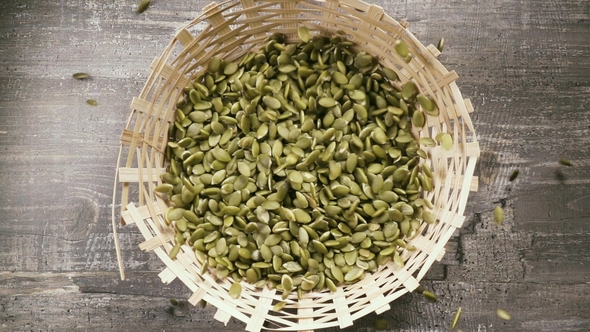 Peeled Pumpkin Seeds Drop Into the Basket Top View