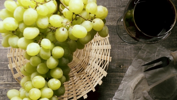 a Bunch of Grapes Falls Into the Basket on the Table Top View