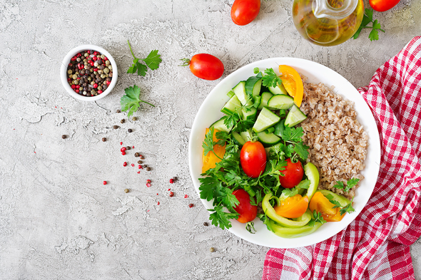 Healthy vegetarian salad of fresh vegetables - tomatoes, cucumber, sweet peppers and porridge Stock Photo by Timolina