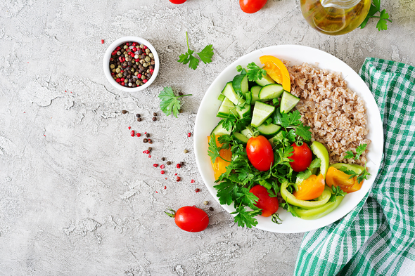 Healthy vegetarian salad of fresh vegetables - tomatoes, cucumber, sweet peppers and porridge Stock Photo by Timolina