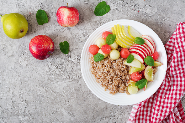 Buckwheat or porridge with fresh melon, watermelon, apple and pear. - Stock Photo - Images