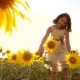 Cute Child Girl in Yellow Garden of Sunflowers Sunlight in Summer. Beautiful Sunset Little Girl - VideoHive Item for Sale