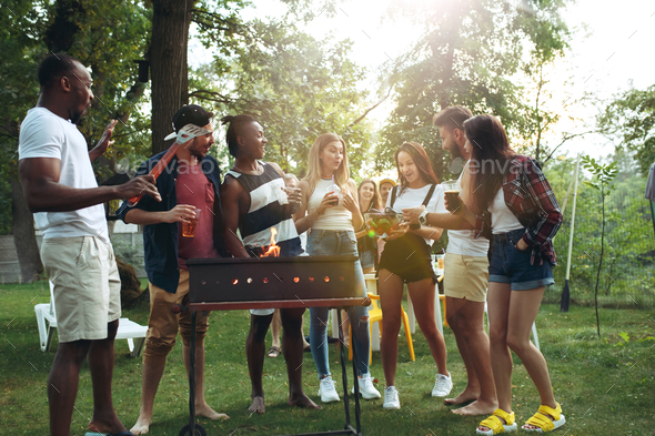 Group of friends making barbecue in the backyard. concept about good and positive mood with friends Stock Photo by master1305