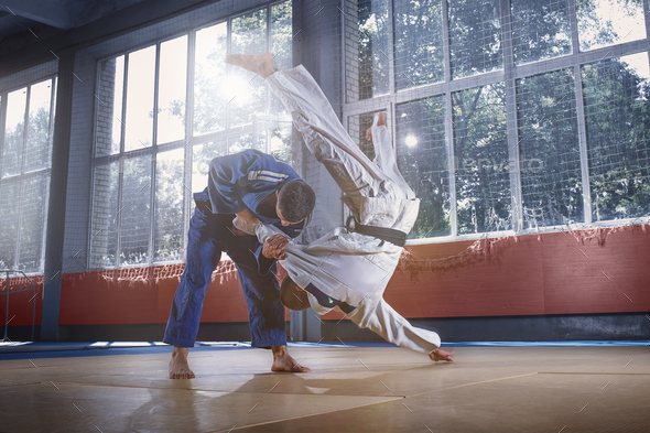Two judo fighters showing technical skill while practicing martial arts in a fight club Stock Photo by master1305